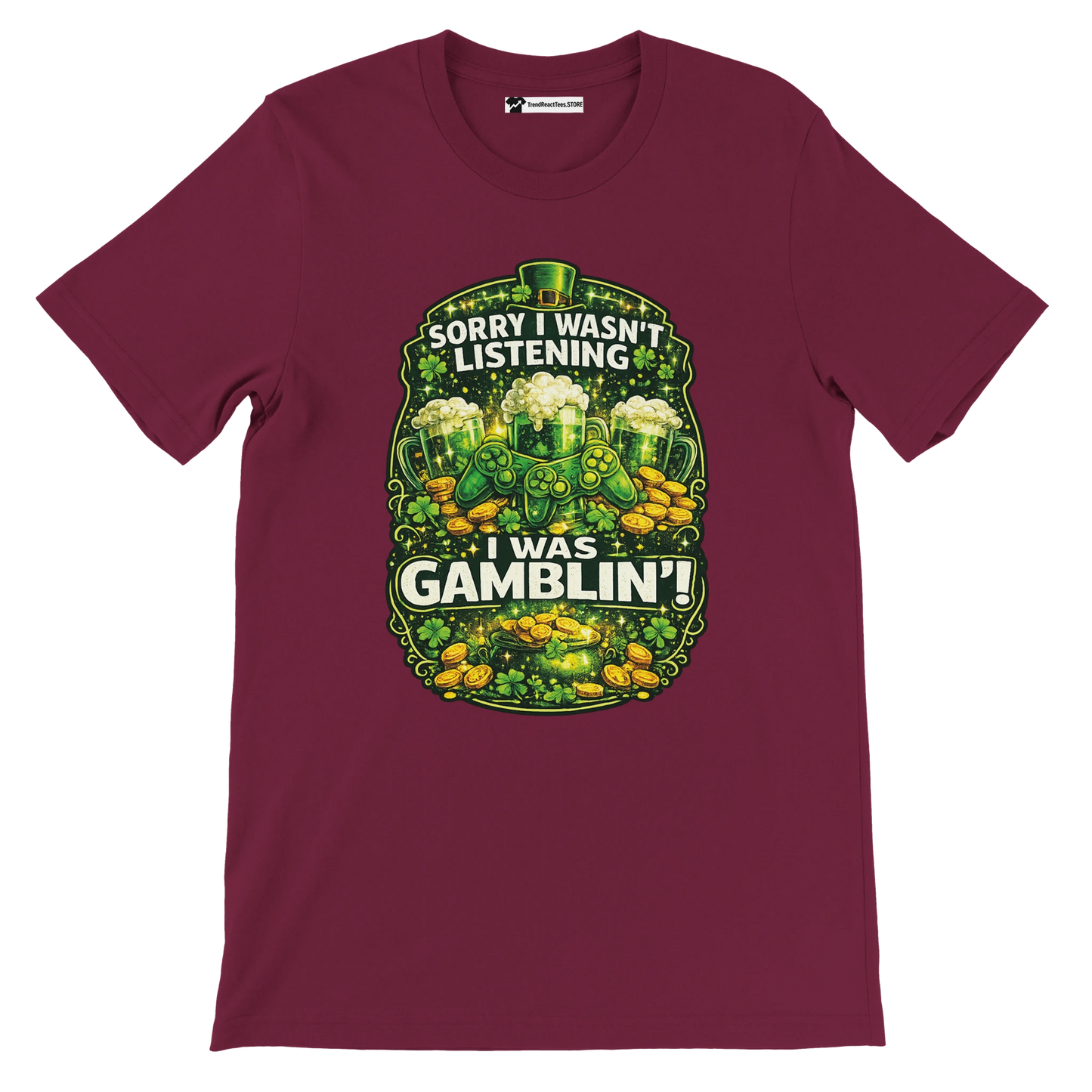 Burgundy t-shirt with St. Patrick's Day theme, beer mugs, game controllers, coins, and 'Sorry I wasn’t listening I was gamblin’' quote.