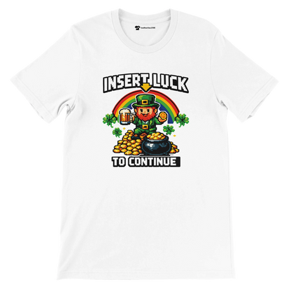 Pixel art leprechaun with rainbow, gold coins, and shamrocks on white tee, 'Insert Luck to Continue'