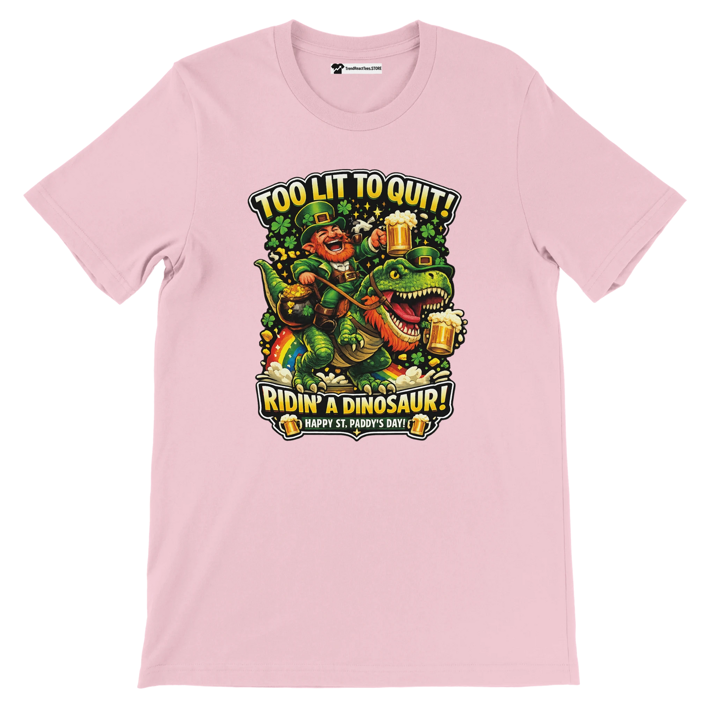 Pink St. Patrick's Day tee with leprechaun riding dinosaur, holding beer, 'Too Lit to Quit' text, shamrocks, rainbow