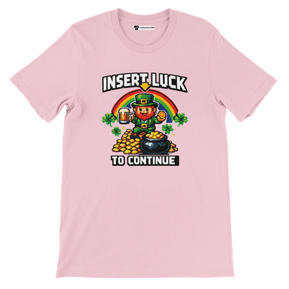 Pink St. Patrick's Day tee with pixel art leprechaun, rainbow, and 'Insert Luck to Continue' text.