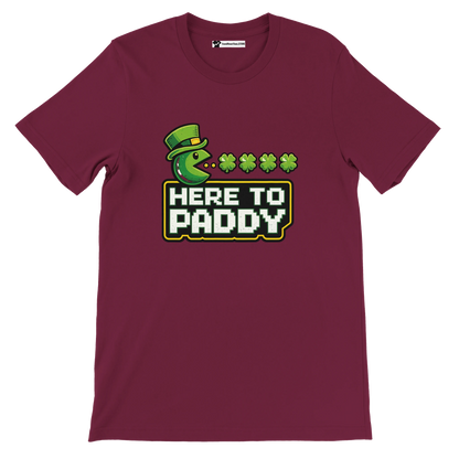 Maroon St. Patrick's Day tee with Pac-Man eating shamrocks, 'Here to Paddy' text, leprechaun hat design