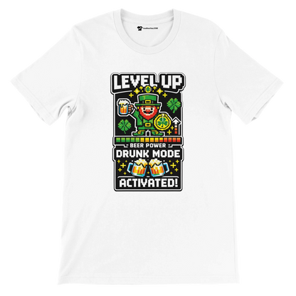White tee with pixel art leprechaun, shamrocks, beer, 'Level Up Drunk Mode Activated' text for St. Patrick's Day