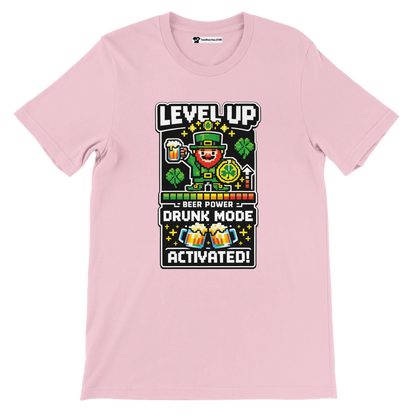 Pink tee with pixel art leprechaun, 'Level Up Drunk Mode Activated' text, shamrocks, and beer mugs for St. Patrick’s Day.
