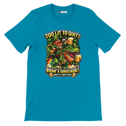 Blue tee with leprechaun riding dinosaur, holding beer, 'Too Lit to Quit' St. Paddy's Day graphic