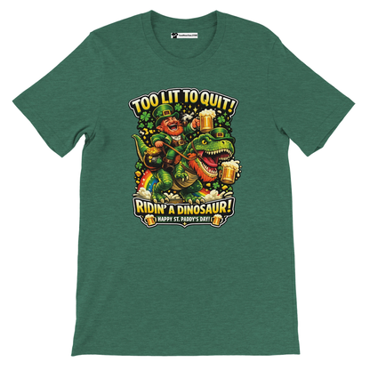 Green St. Patrick's Day tee with leprechaun riding dinosaur, holding beer, text 'Too Lit to Quit! Ridin' a Dinosaur!'