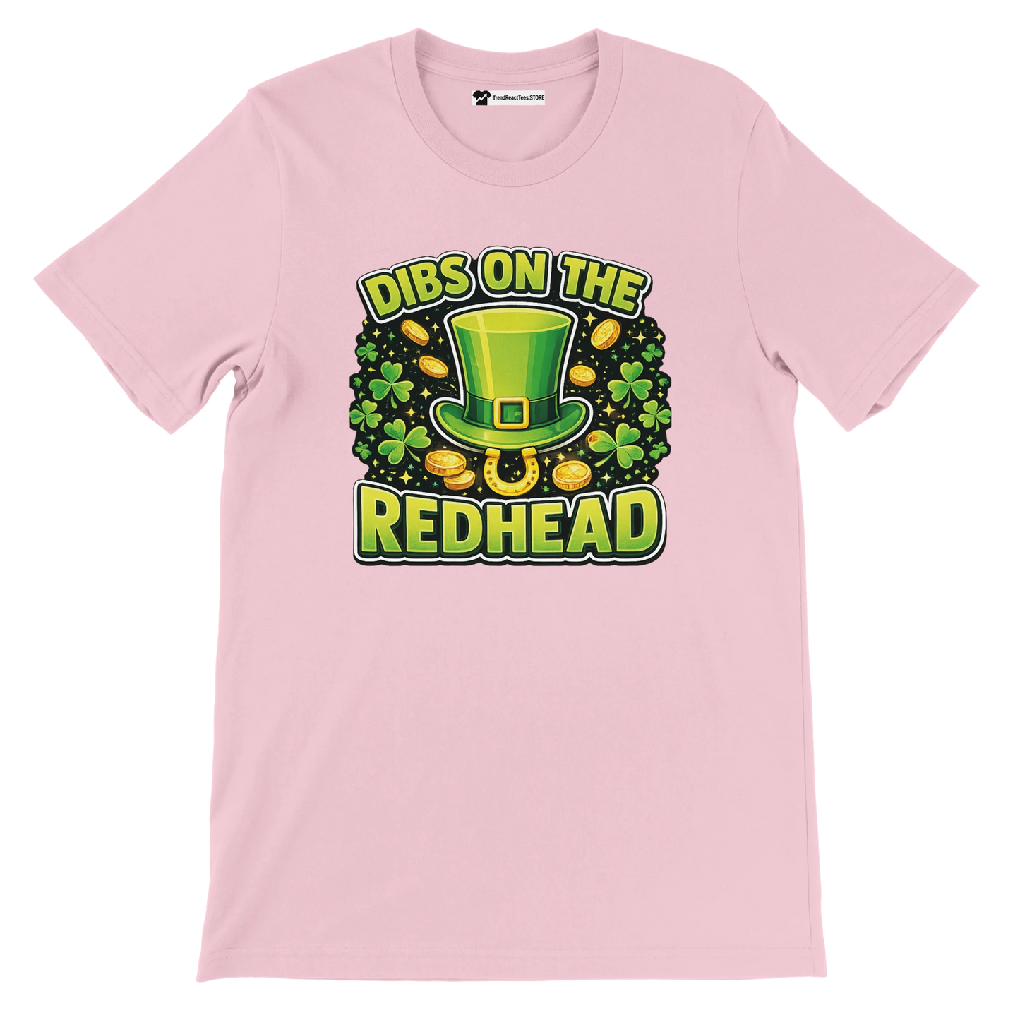 Pink t-shirt with St. Patrick's Day design, green leprechaun hat, shamrocks, gold coins, and 'Dibs on the Redhead' quote.