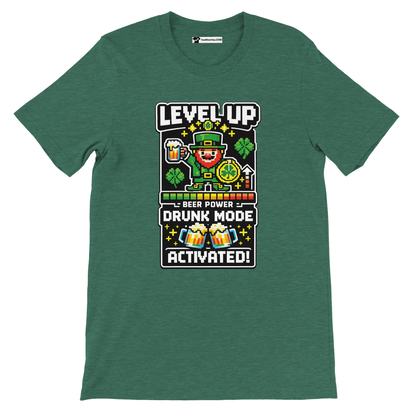 Green St. Patrick's Day tee with pixel leprechaun, 'Level Up Drunk Mode Activated' text, shamrocks, beer mugs