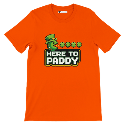 Orange St. Patrick's Day tee with Pac-Man eating shamrocks, 'Here to Paddy' text, green hat graphic