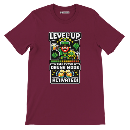 Maroon St. Patrick's Day tee with pixel leprechaun, beer, shamrocks, 'Level Up Drunk Mode Activated' graphic