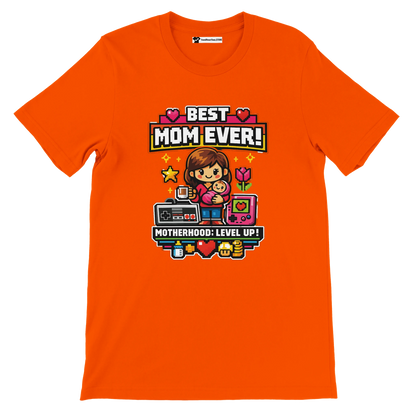 Orange tee with pixel art mom holding child, retro game icons, text 'Best Mom Ever! Motherhood: Level Up!'.