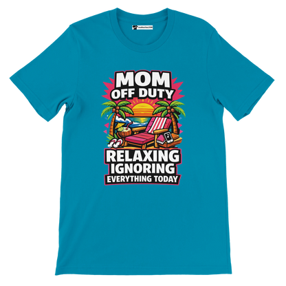 Blue t-shirt with 'Mom Off Duty' tropical beach lounge chair and sunset graphic, humorous quote.