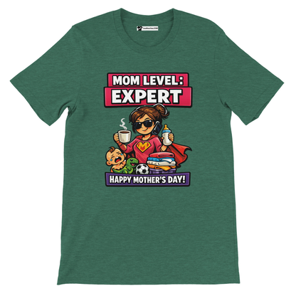 Green tee with cartoon mom superhero, toddler, toys, and text 'Mom Level: Expert. Happy Mother's Day!'
