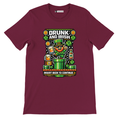 Maroon 'Drunk and Irish' tee with pixel leprechaun, beer, shamrocks, and 'Insert Beer to Continue' gaming design for St. Patrick's Day.