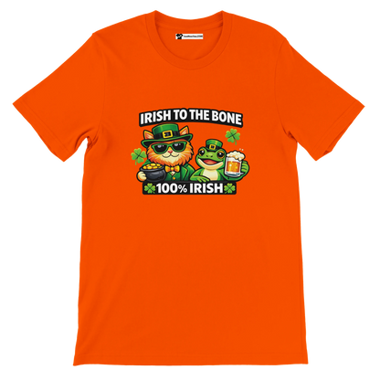 Orange St. Patrick's Day tee with cat and frog in green hats, 'Irish to the Bone' text, shamrocks, beer, and gold coins.