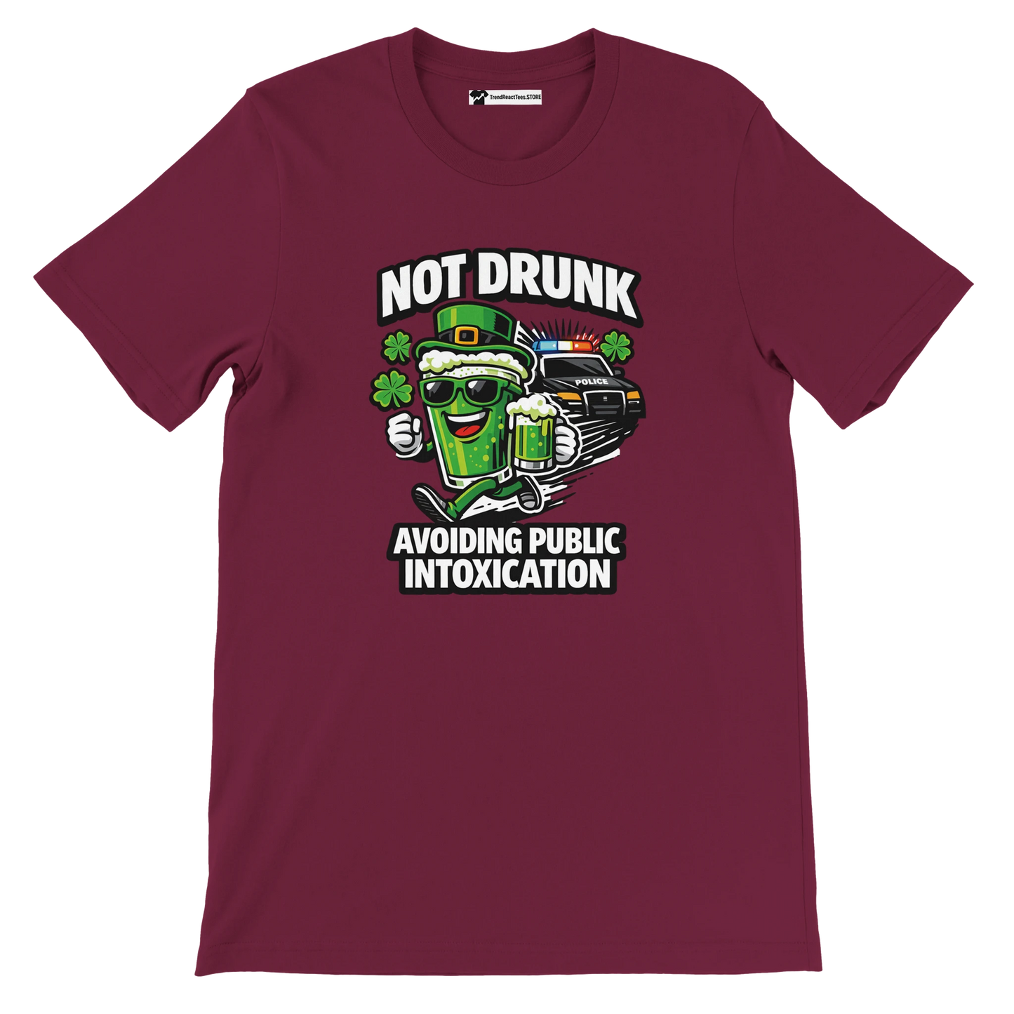 Maroon tee with cartoon beer mug, police car, clovers, and text 'Not Drunk Avoiding Public Intoxication'.