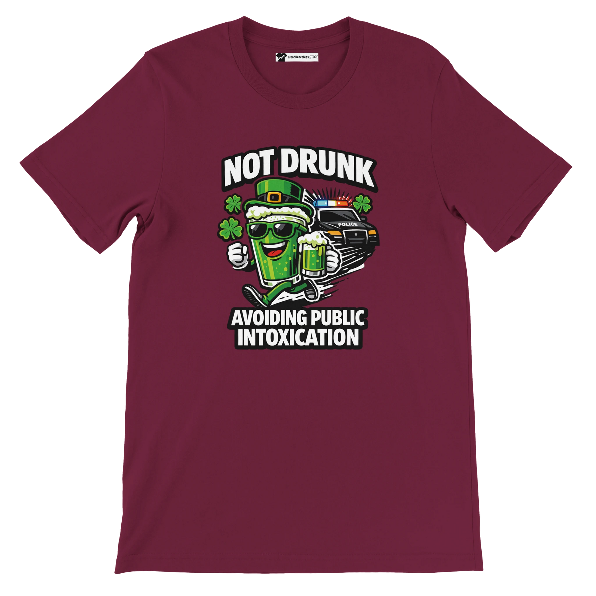 Maroon tee with cartoon beer mug, police car, clovers, and text 'Not Drunk Avoiding Public Intoxication'.