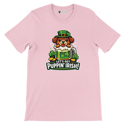 Pink t-shirt with cute dog in leprechaun hat, clovers, gold coins, and 'Let’s Get Puppin’ Irish!' quote.