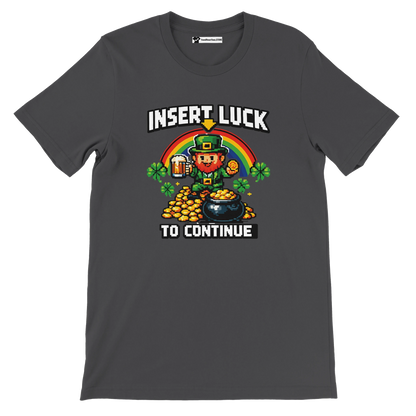 Pixel art leprechaun with rainbow, gold, and beer on dark gray tee, 'Insert Luck to Continue' text.