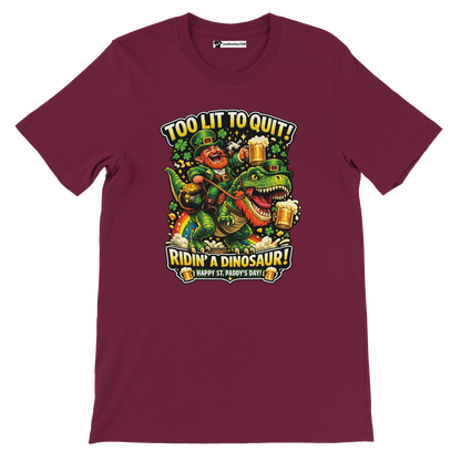 Funny St. Patrick's Day tee with leprechaun riding dinosaur, beer, shamrocks, and 'Too Lit to Quit' text