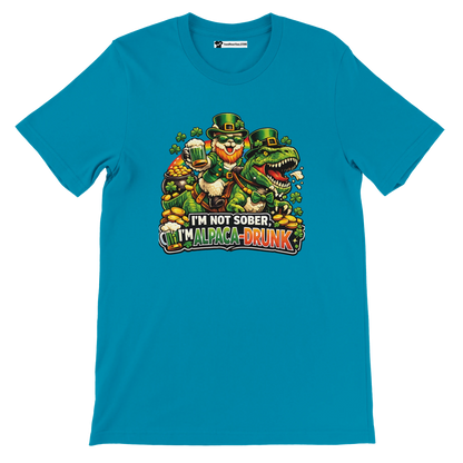 Funny St. Patrick's Day tee with leprechaun riding dinosaur, shamrocks, gold coins, and 'I'm Alpaca-Drunk' text