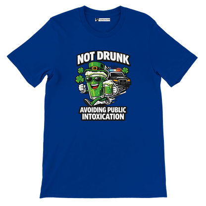 Blue t-shirt with cartoon green beer, clovers, police car, and text Not Drunk Avoiding Public Intoxication.