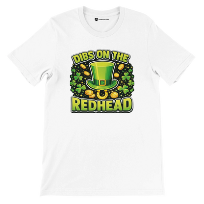 White St. Patrick’s Day t-shirt with green hat, shamrocks, gold coins, and “Dibs on the Redhead” text.