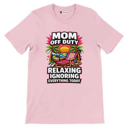 Pink t-shirt with 'Mom Off Duty' beach sunset, palm trees, lounge chair, and relaxing quote graphic.