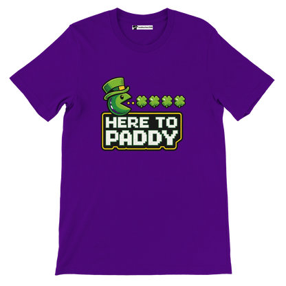 Purple tee with green Pac-Man in leprechaun hat, shamrocks, and 'HERE TO PADDY' text for St. Patrick's Day.
